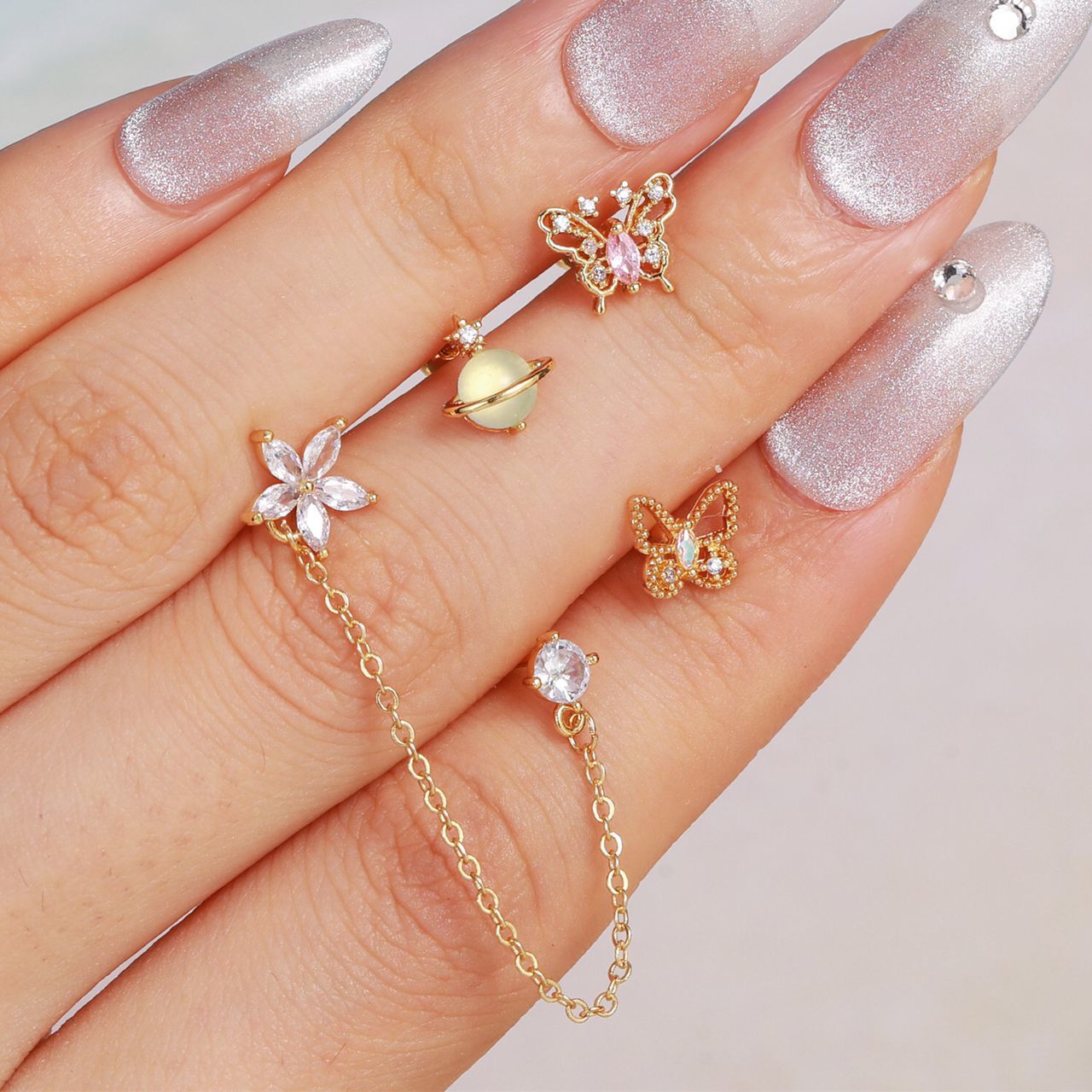 piercing dorado de flor, piercing doble, piercing de flor con piedra, piercing largo